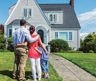 Family Standing in front of New Home